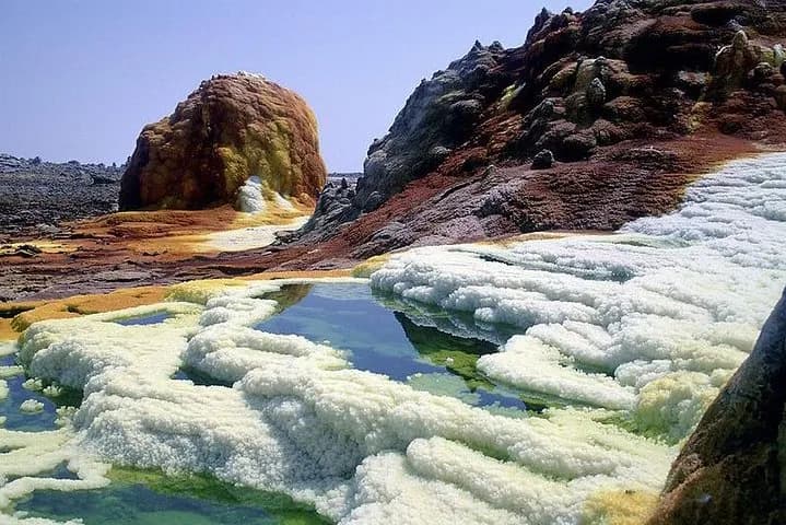 Journey to one of Earth's most extreme environments - the Danakil Depression, with its sulfur springs, salt flats, active volcanoes, and colorful hydrothermal fields creating an otherworldly landscape